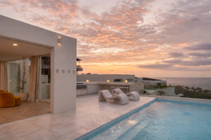 Luxury cliffside villa with infinity pool overlooking the ocean at sunset in Bali